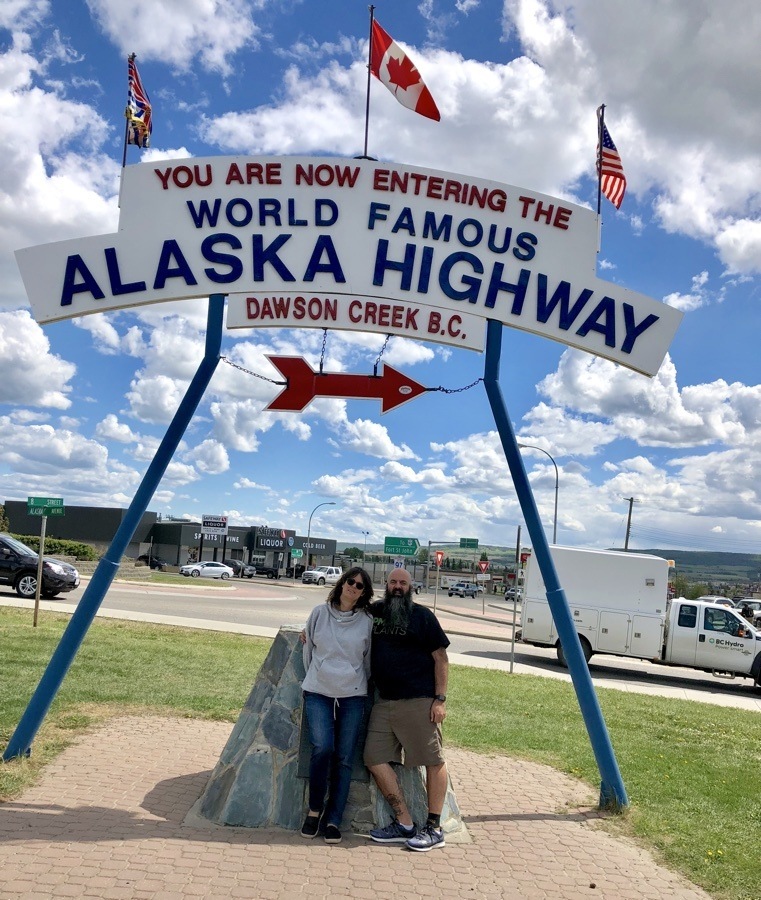 kevin and laura at the alaska highway sign.
