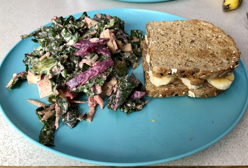 kale salad with creamy garlicky dressing and almond butter and banana sandwich.
