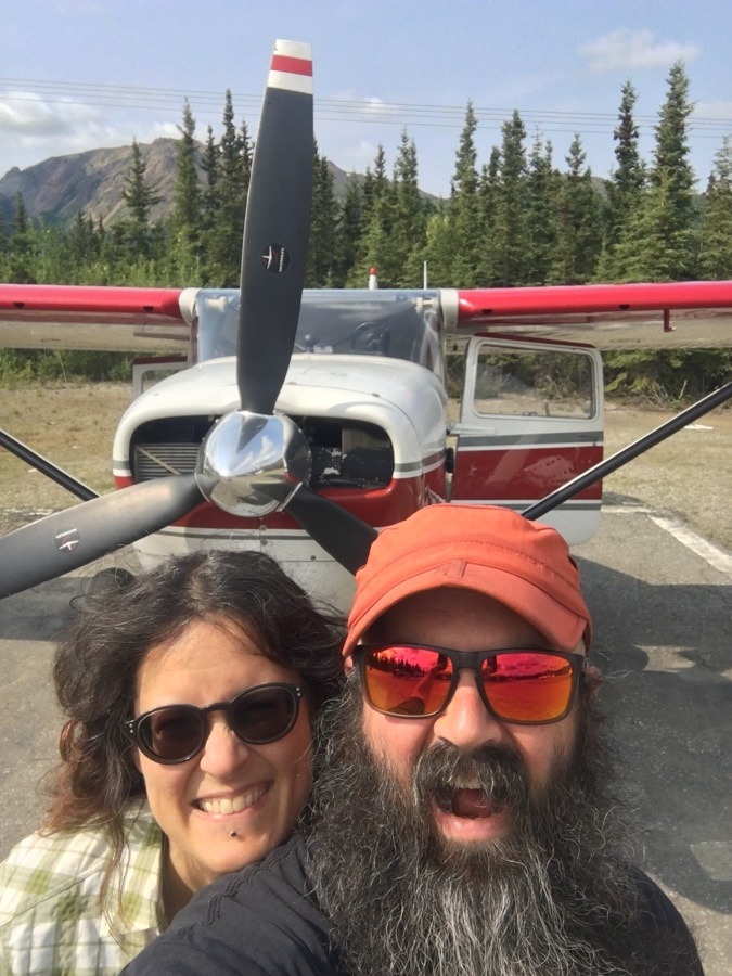 Laura and Kevin in front of a prop plane.