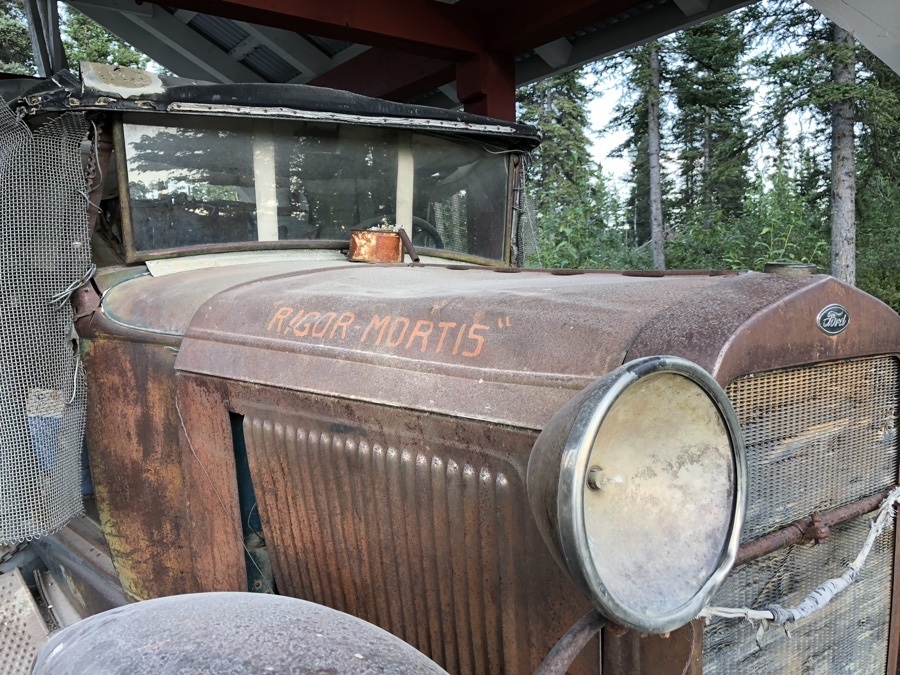 old car by the footbridge to mccarthy alaska.