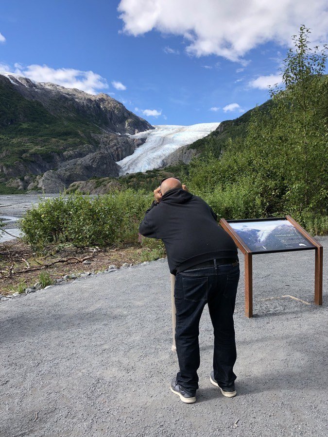 kevin looking at exit glacier through binoculars.