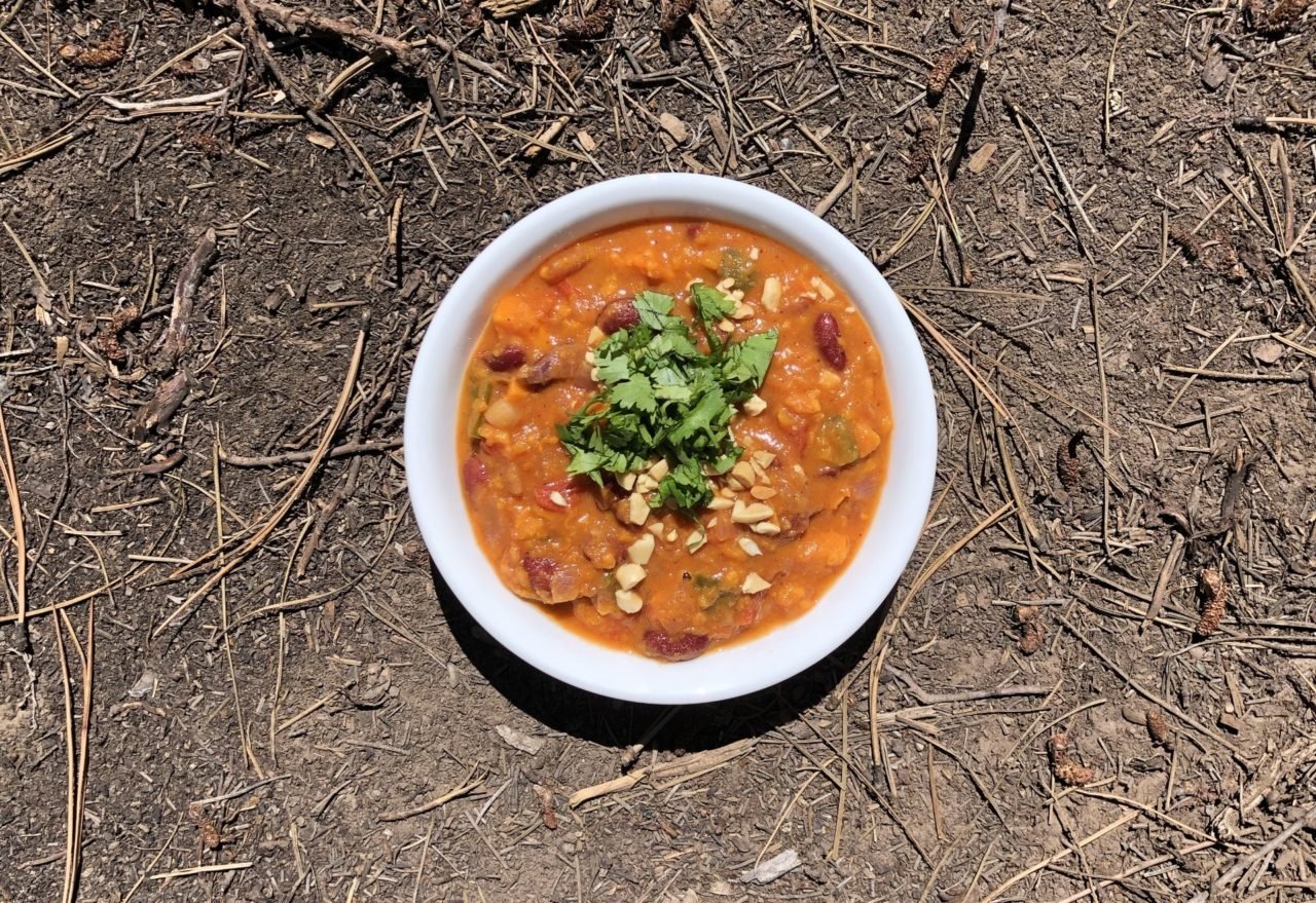 african sweet potato and peanut stew in a white bowl.