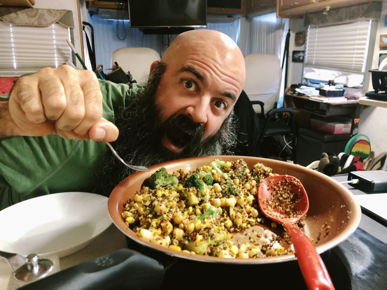 kevin and a pan of chickpea quinoa curry bowl.