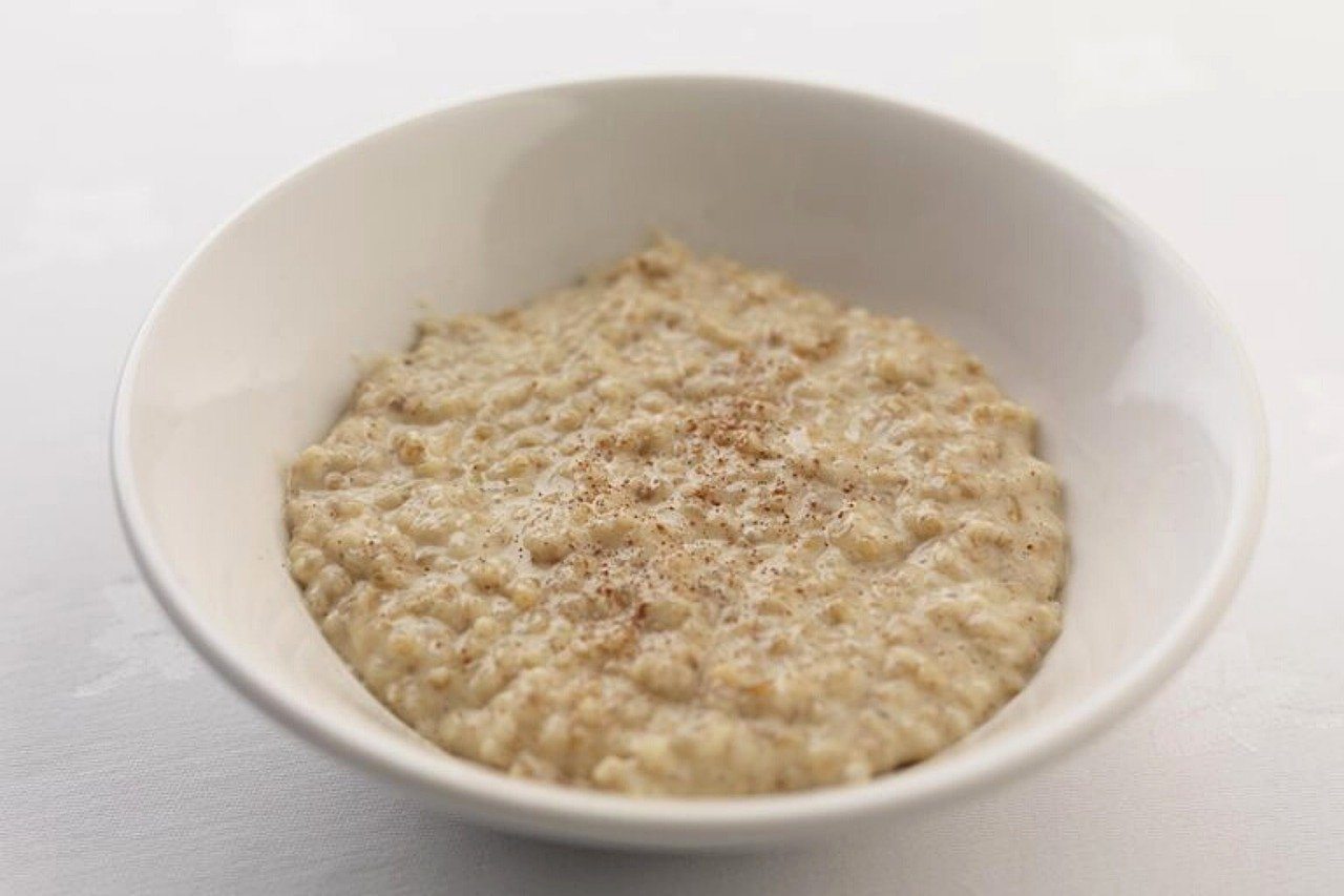 cooked oatmeal in a white bowl.