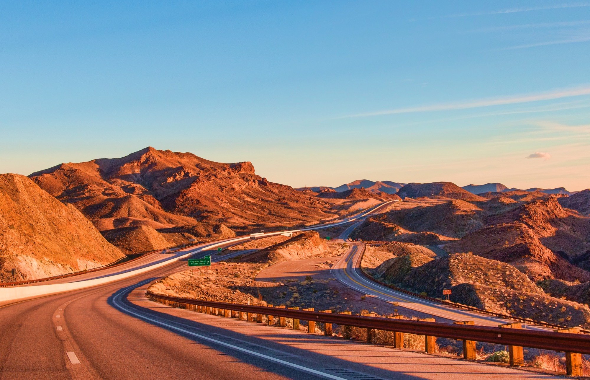 landscape photography showing red rocks near a highway.