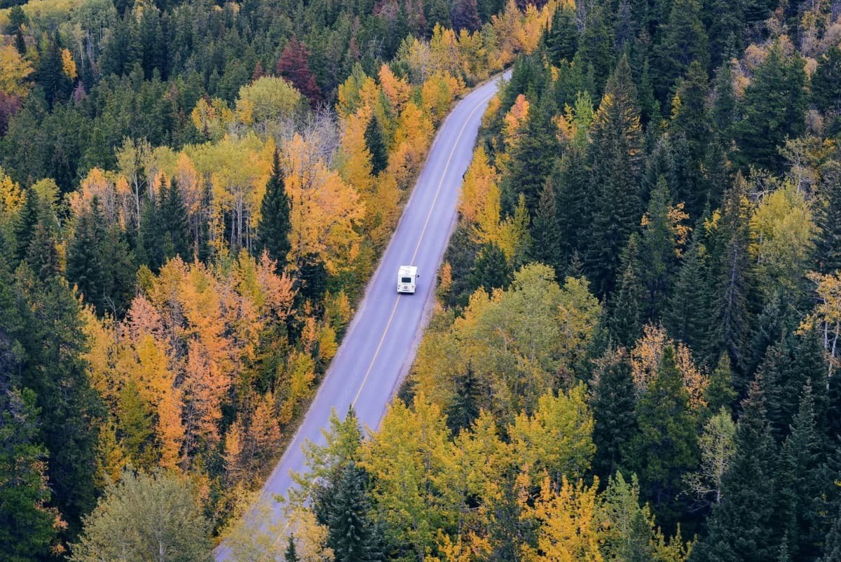 overhead view of an rv on a road with fall colors around.