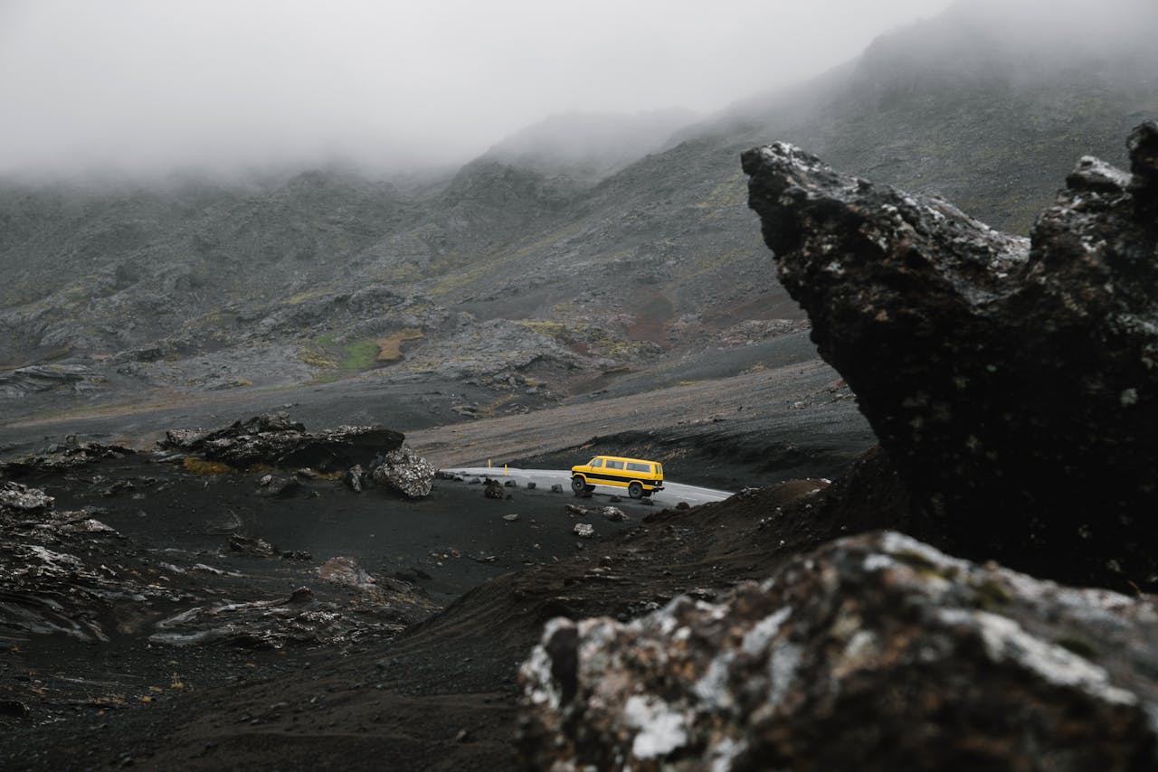 van on a road with a moody, foggy background.